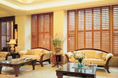 Lounge-full-length-golden-plantation-shutters